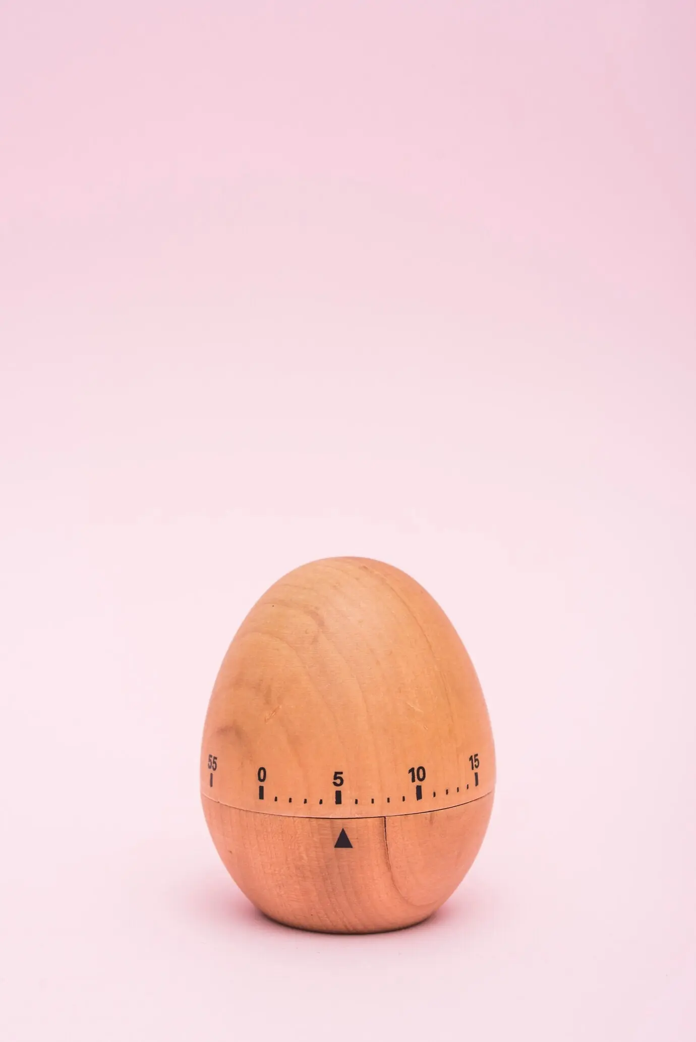 Egg timer against a pink backdrop.