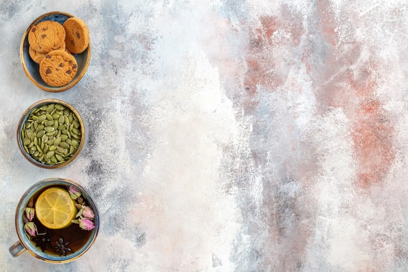 Overhead view of a cup of tea with biscuits.